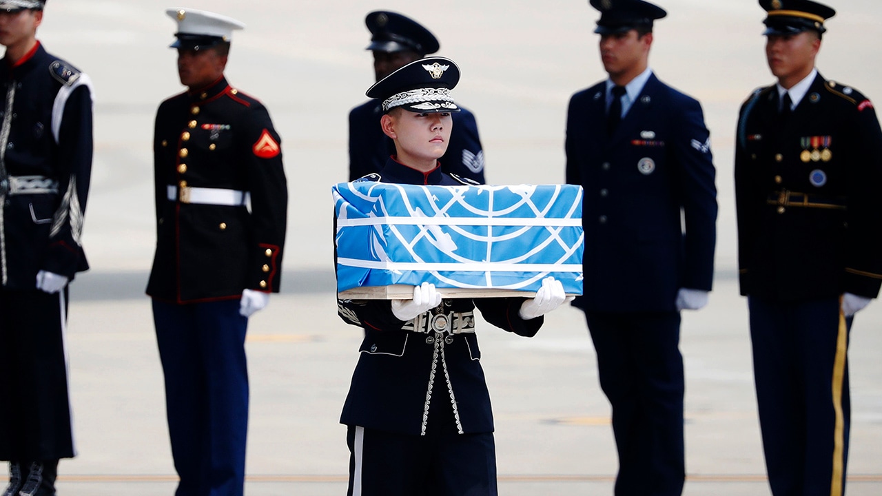Photo of soldier carrying a casket containing a remain of a US soldier
