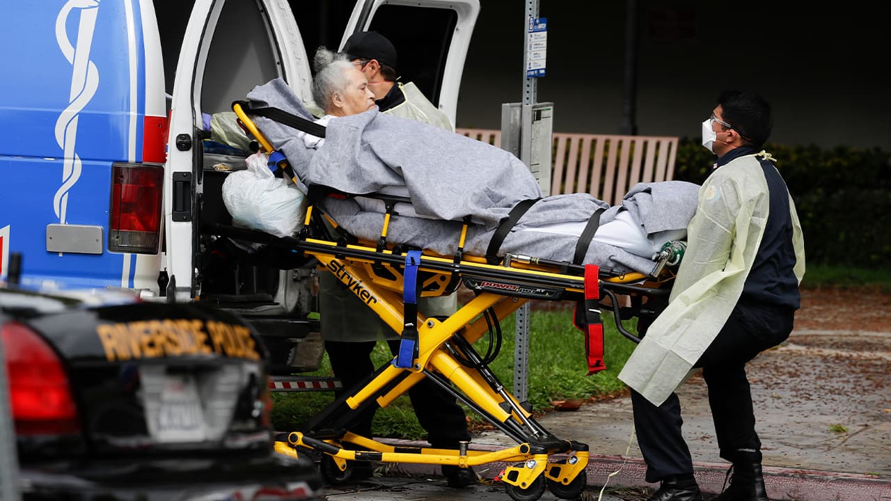 Photo of a patient being taken away from a nursing home