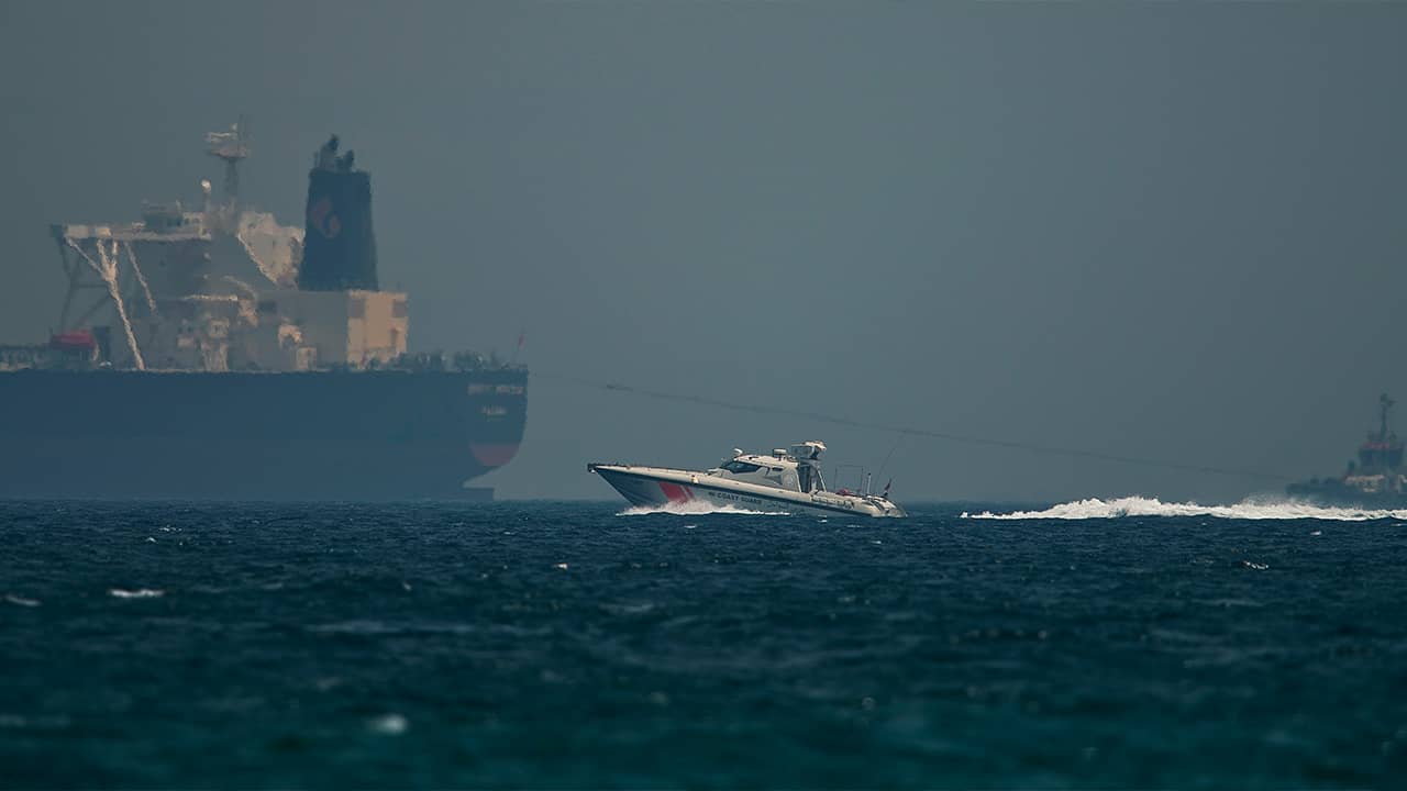 Photo of Emirati coast guard vessel passing an oil tanker