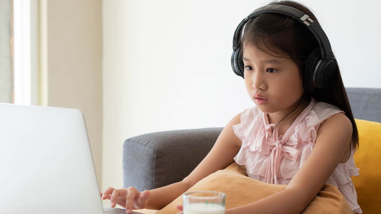 Photo of a young girl engaged in distance learning