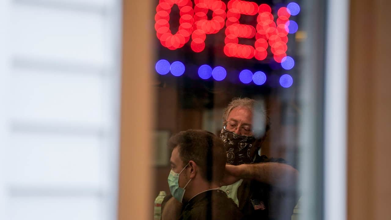 Photo of an open sign at a barber shop 