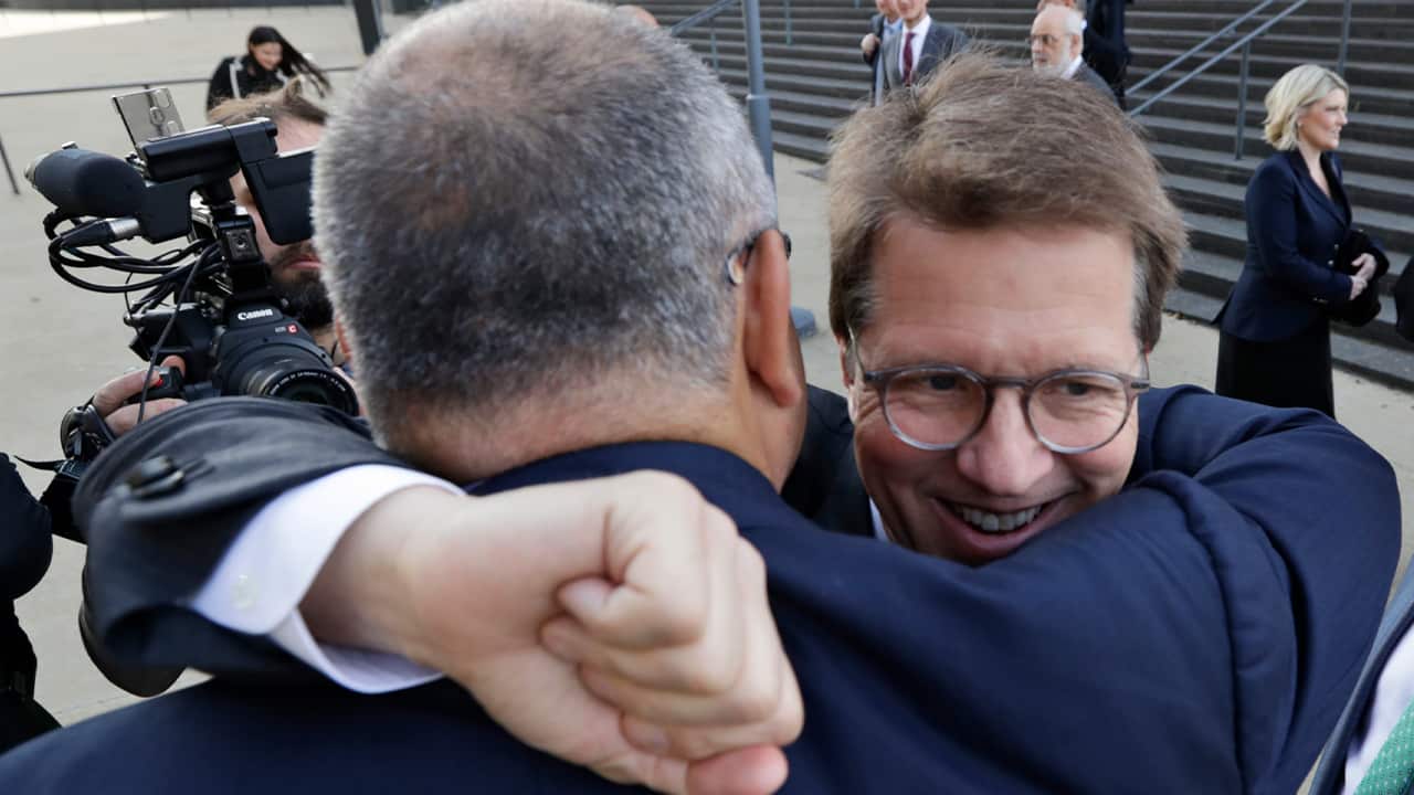 Photo of Attorney Mark Lanier getting a hug