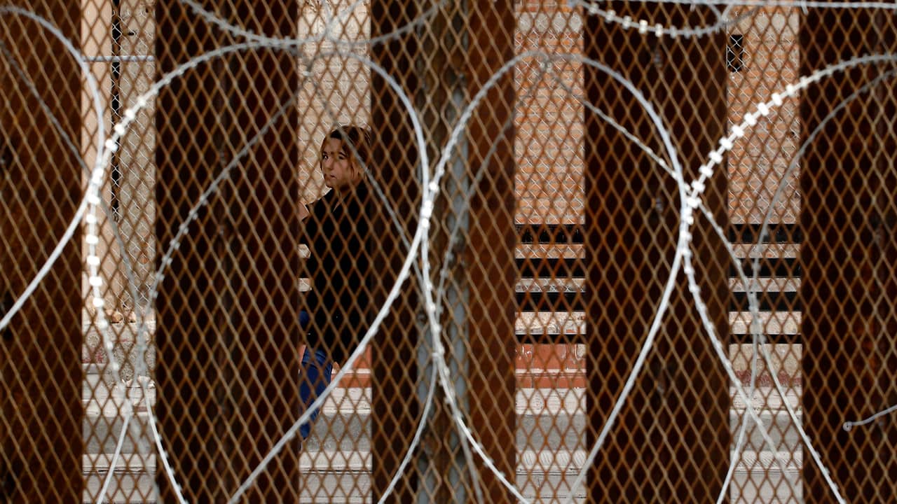 Photo of razor wire covered border wall
