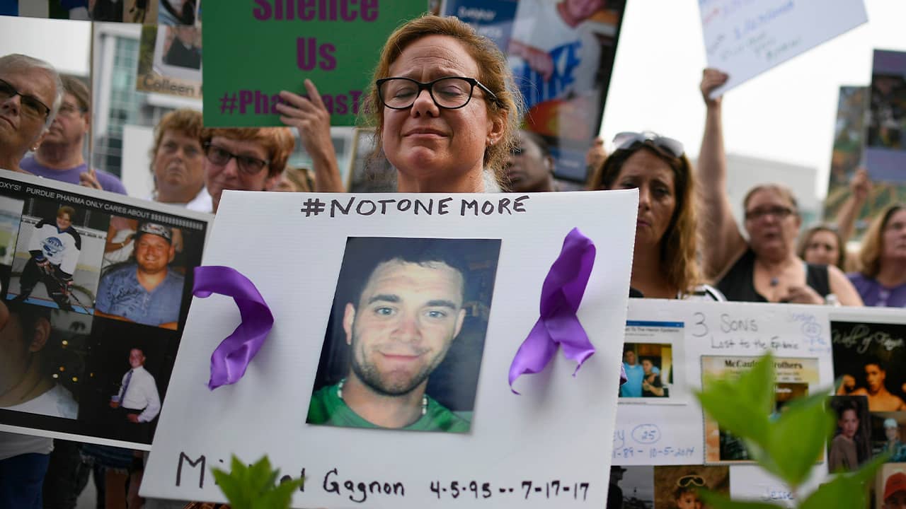 Photo of Christine Gagnon holding a sign during a protest