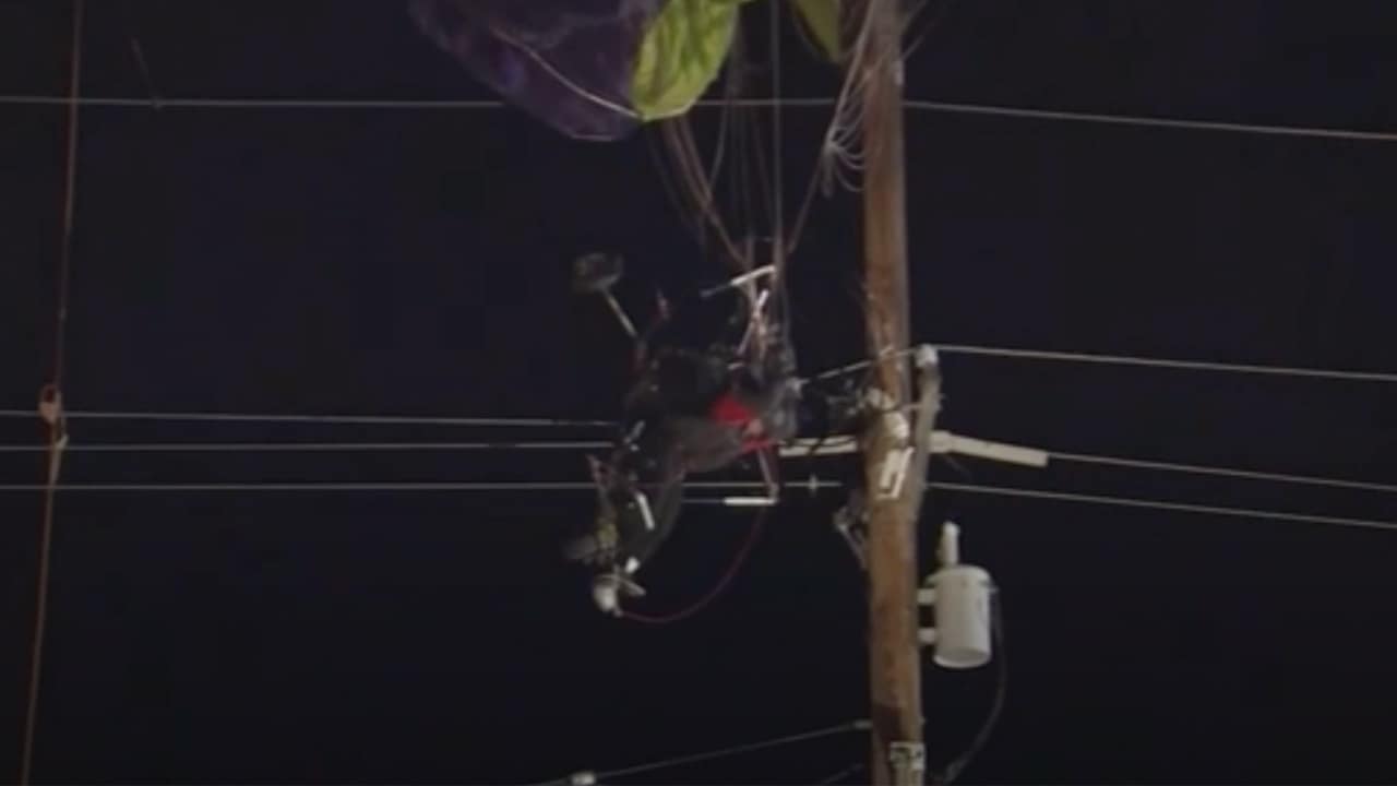 Photo of a paraglider trapped in a power line