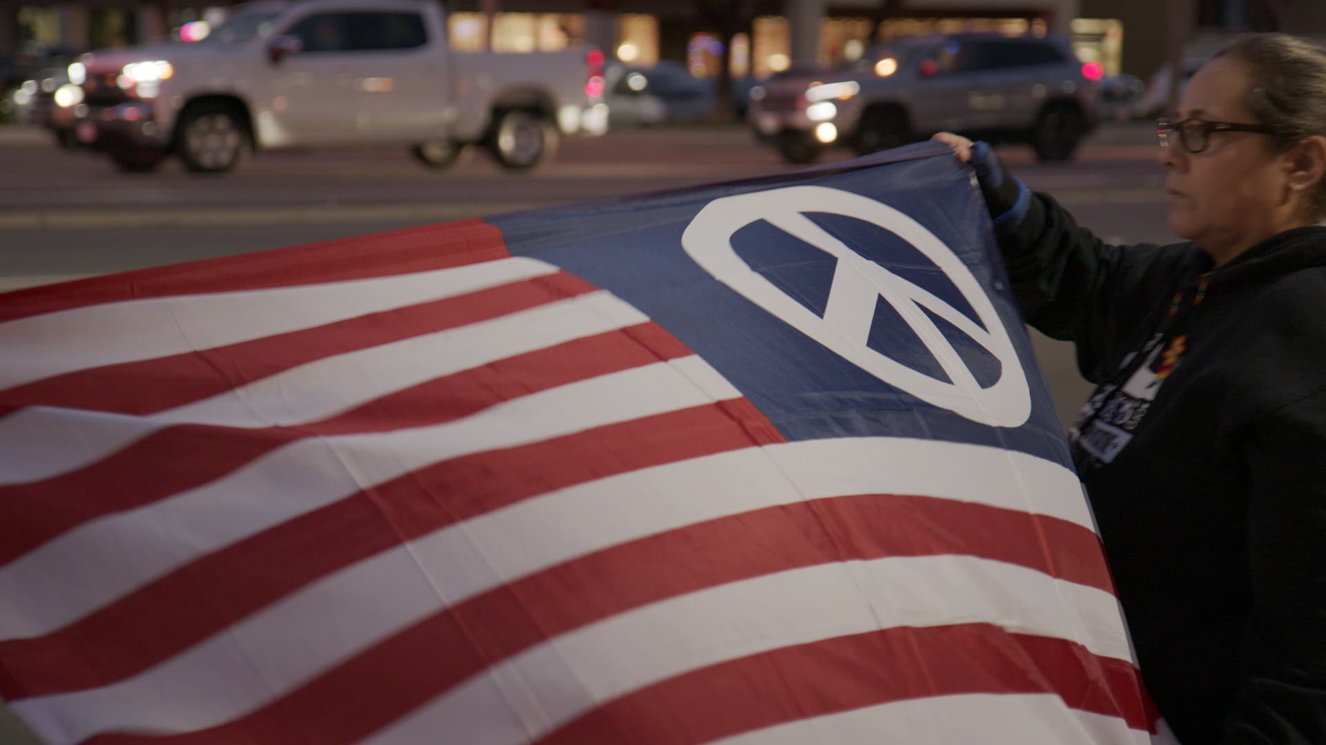 Photo of an American flag with a peace symbol