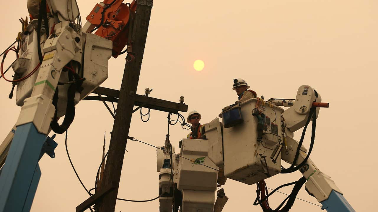 Photo of PG&E workers working to restore power lines in 2018