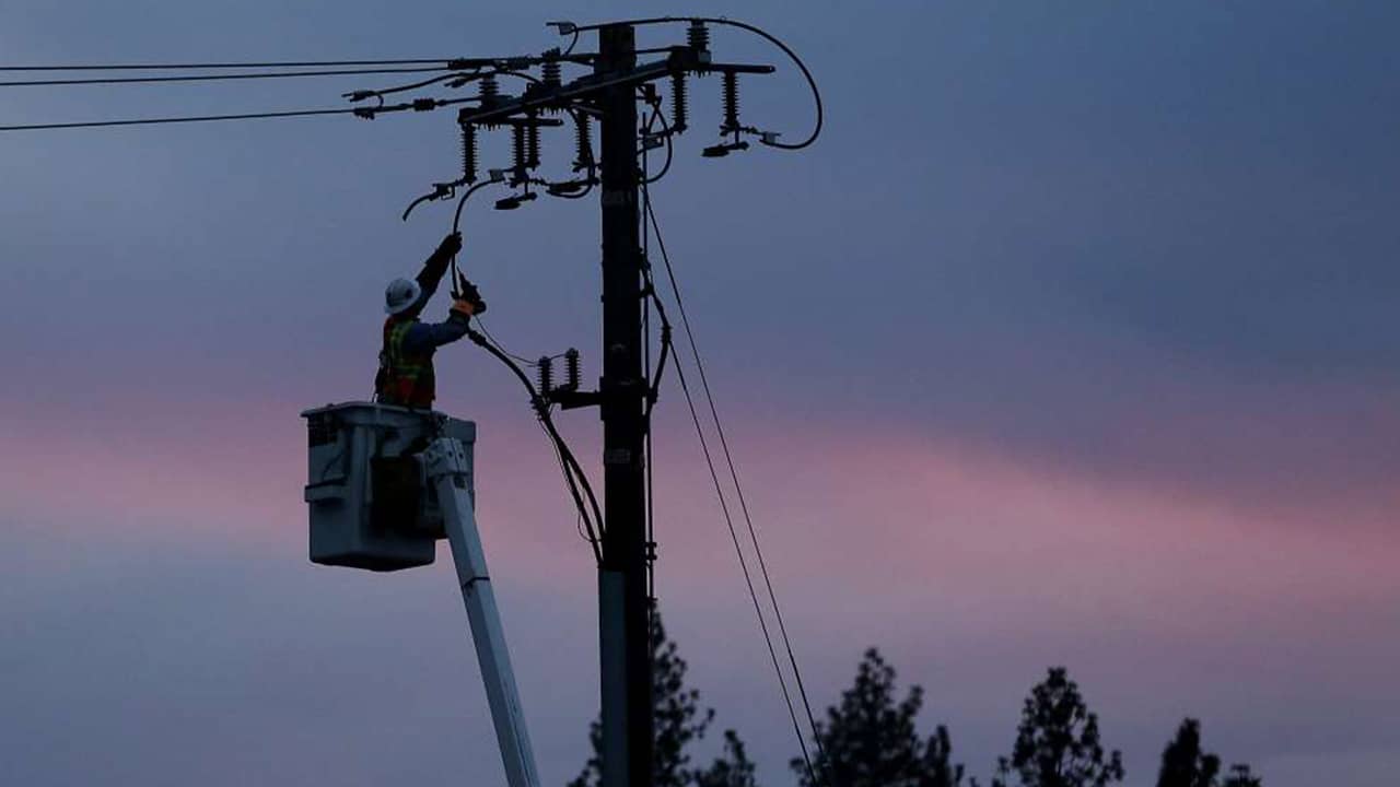 Photo of PG&E line worker at sunset