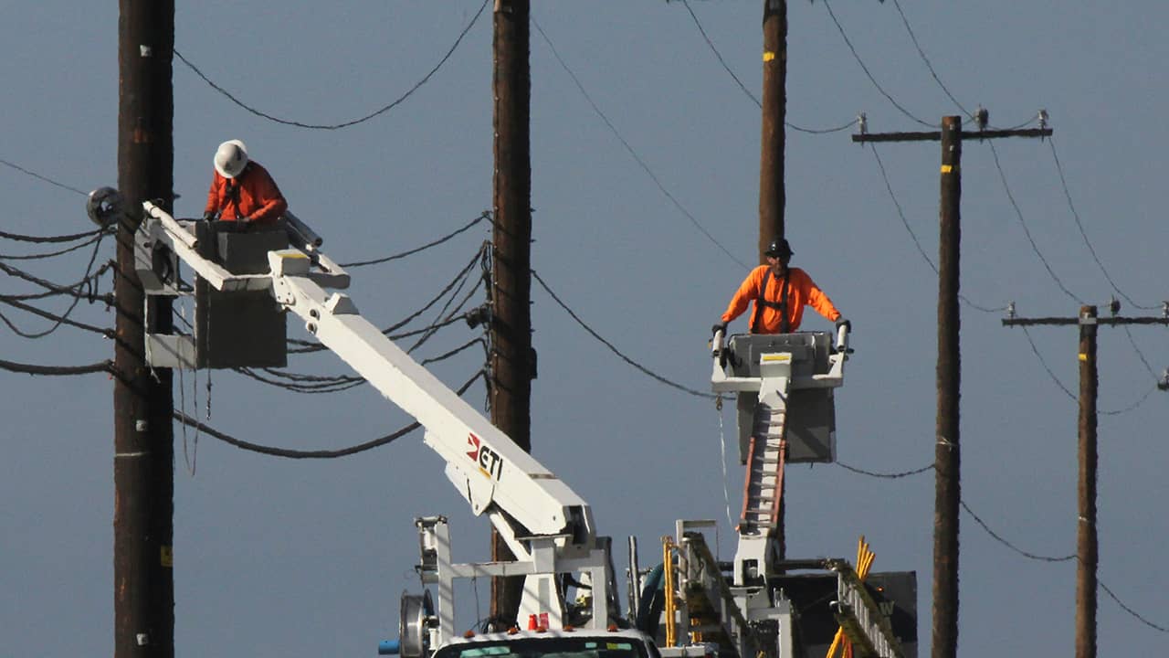 Photo of utility crews repairing overhead lines along the PCH