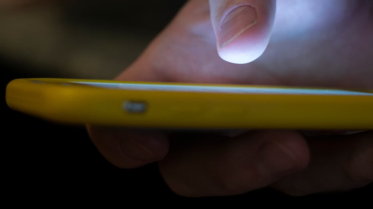 Photo of a man using a cell phone