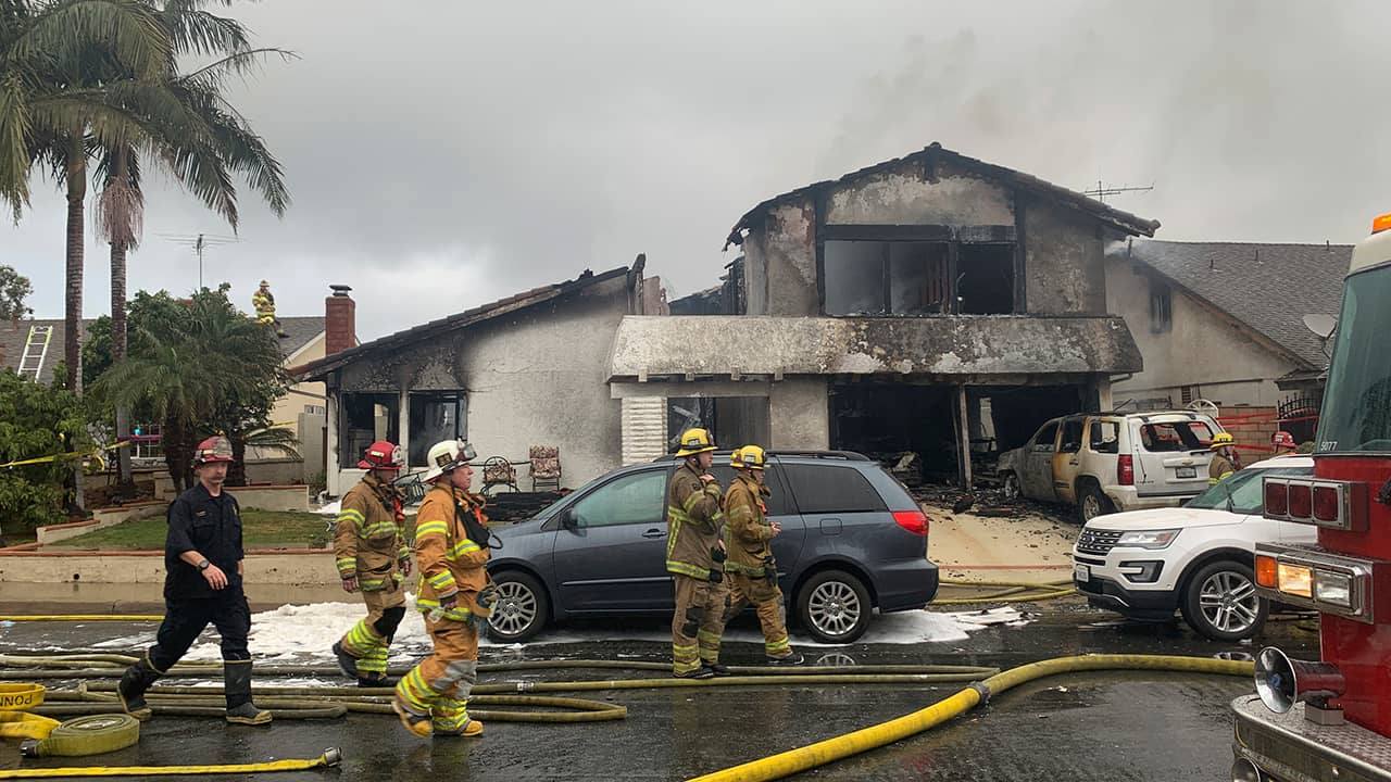 Photo of plane crash scene and firefighters