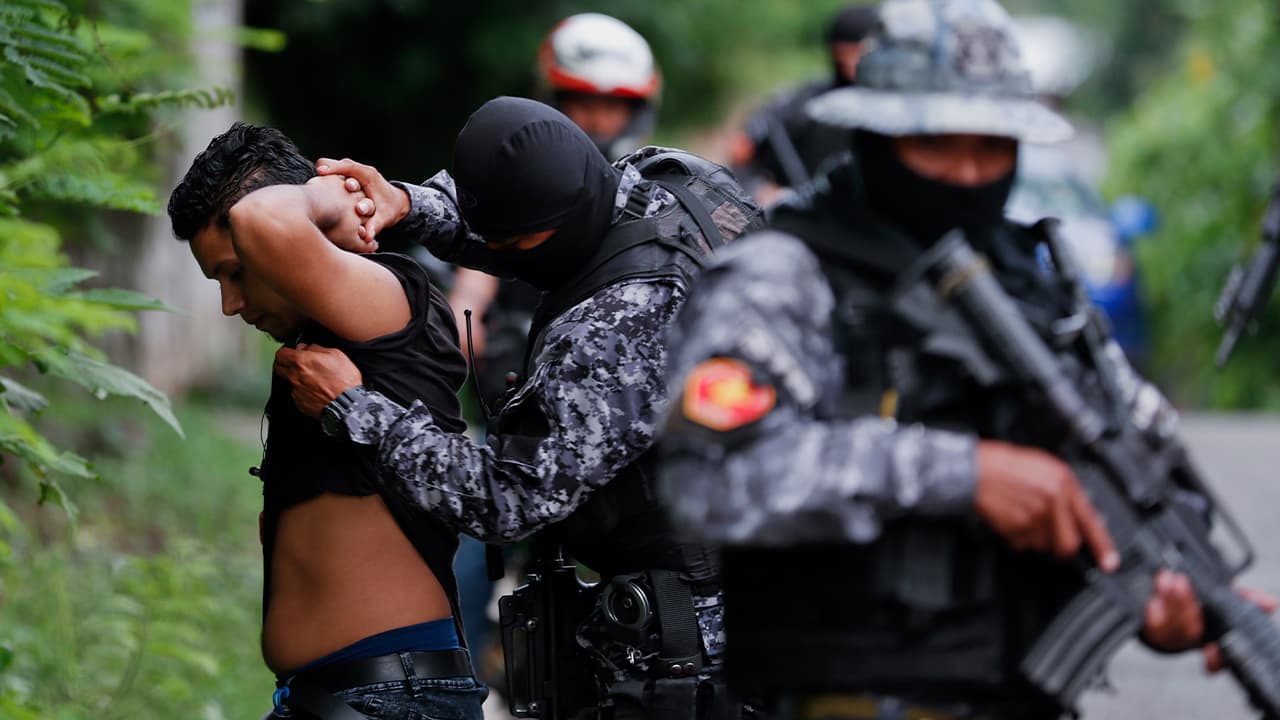 Photo of police frisking a man in El Salvador