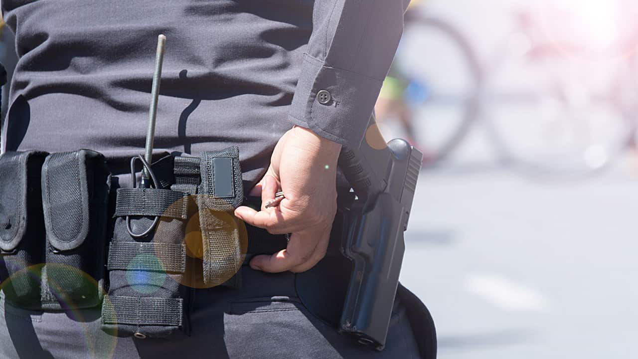 Photo of a police belt and gun