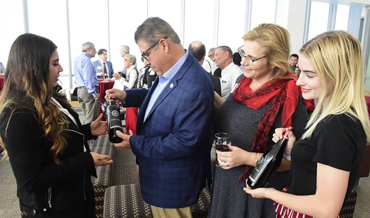 Photo of wine presentation to Fresno State President Joseph Castrohe un