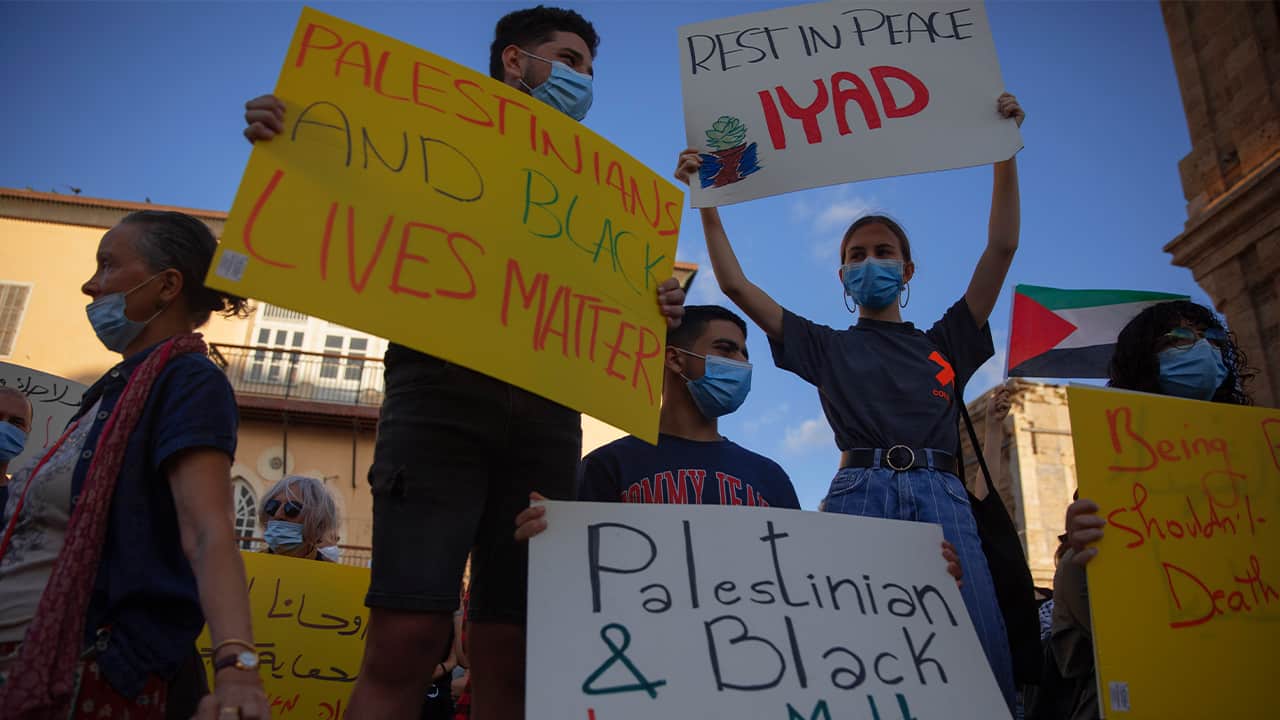 Photo of protesters holding signs