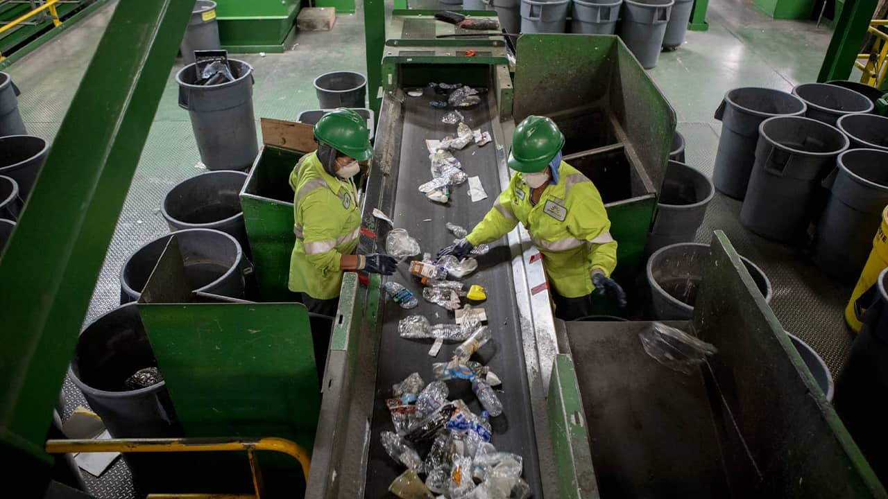 Photo of workers sorting through plastic items