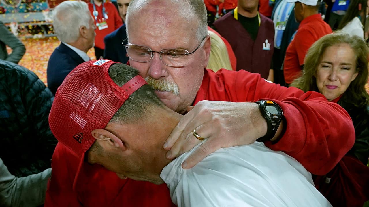 Photo of Kansas City Chiefs head coach Andy Reid, rear, putting his arm around San Francisco 49ers head coach Kyle Shanahan