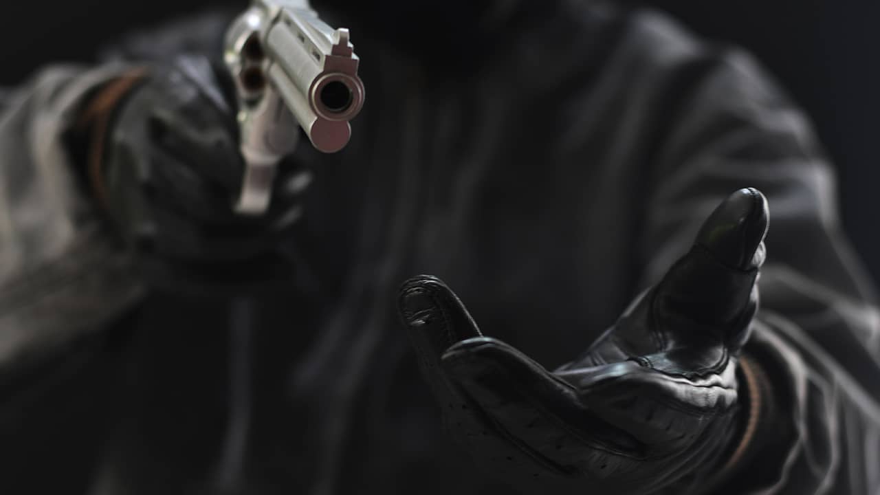 Photo of armed robber pointing a gun