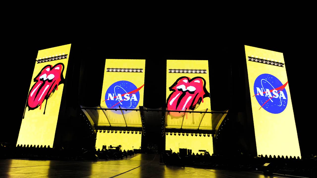 Photo of logos for The Rolling Stones and NASA displayed onstage before their concert at the Rose Bowl 