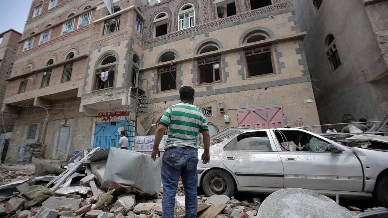 Photo of people inspecting the site of an airstrike