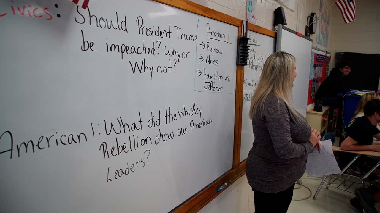 Photo of a civics teacher standing before her class 