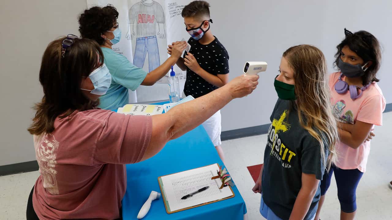 Image of masked students being given temperature checks in Wylie, Texas
