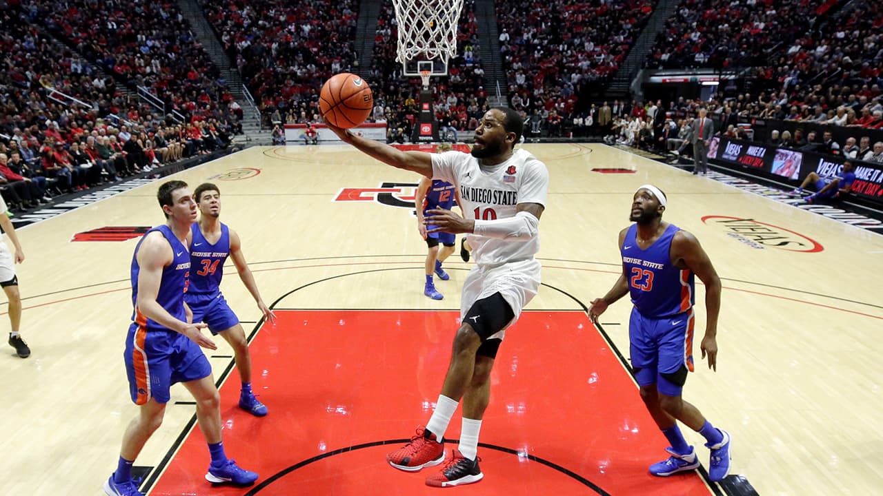 Photo of KJ Feagin shooting an acrobatic layup.