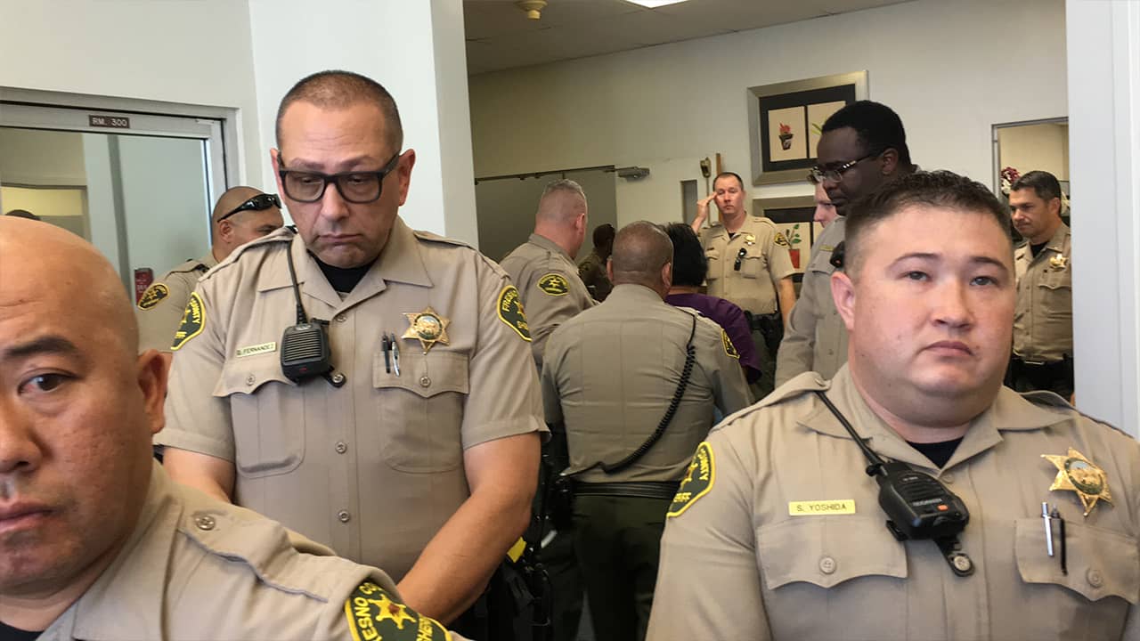 Photo of sheriff deputies escorting Martha Valladarez away