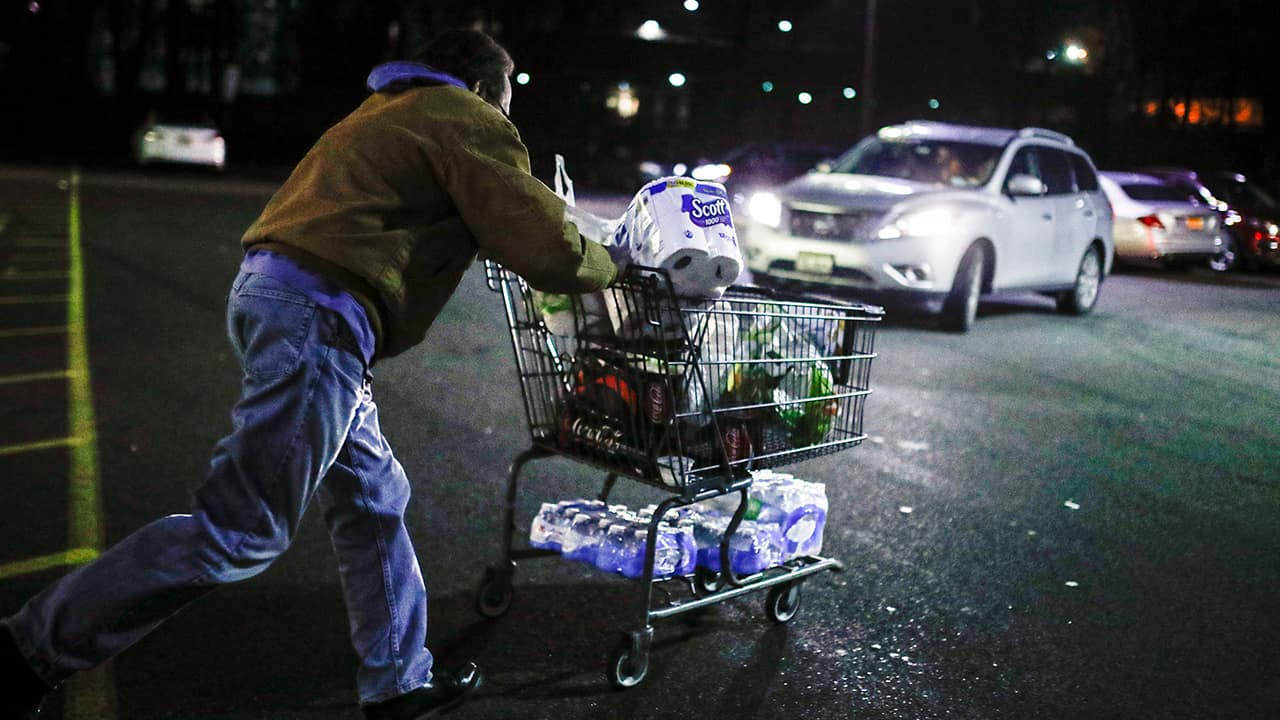 Photo of a man running with a shopping cart 