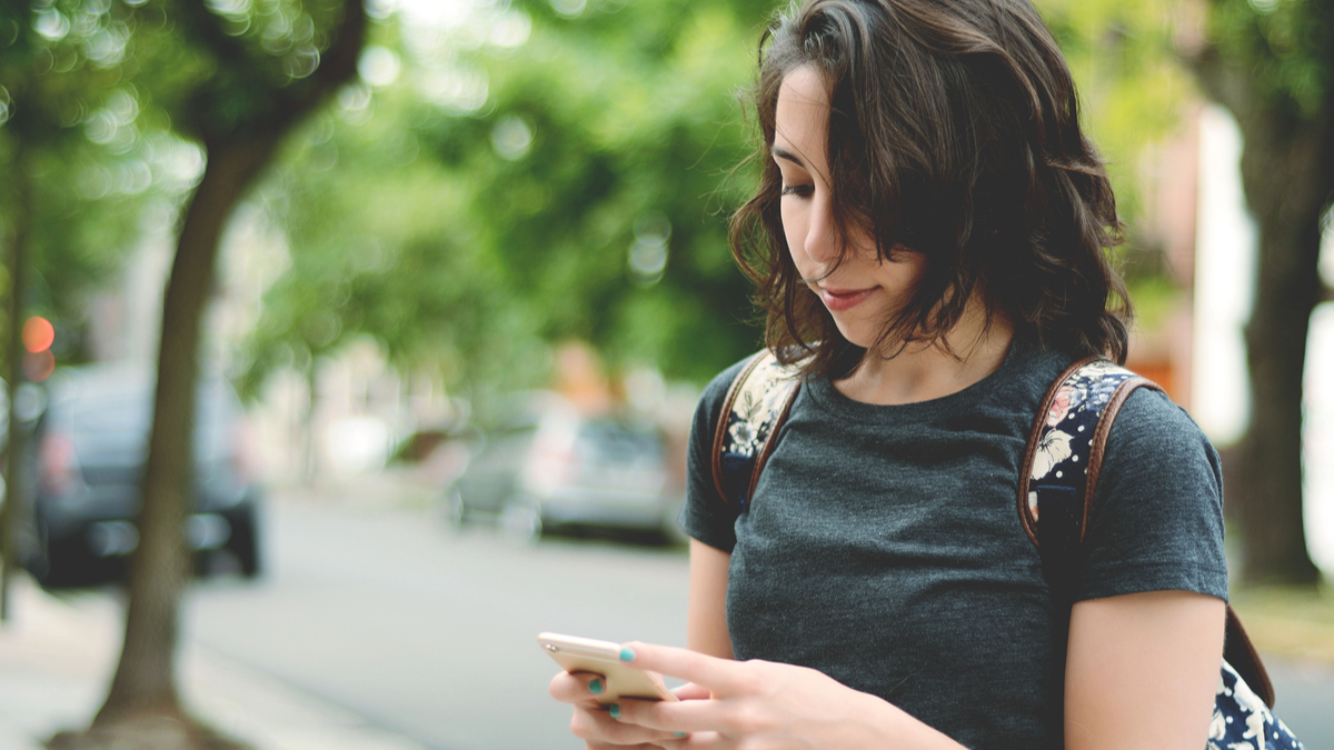 Photo of a woman checking her smartphone for messages