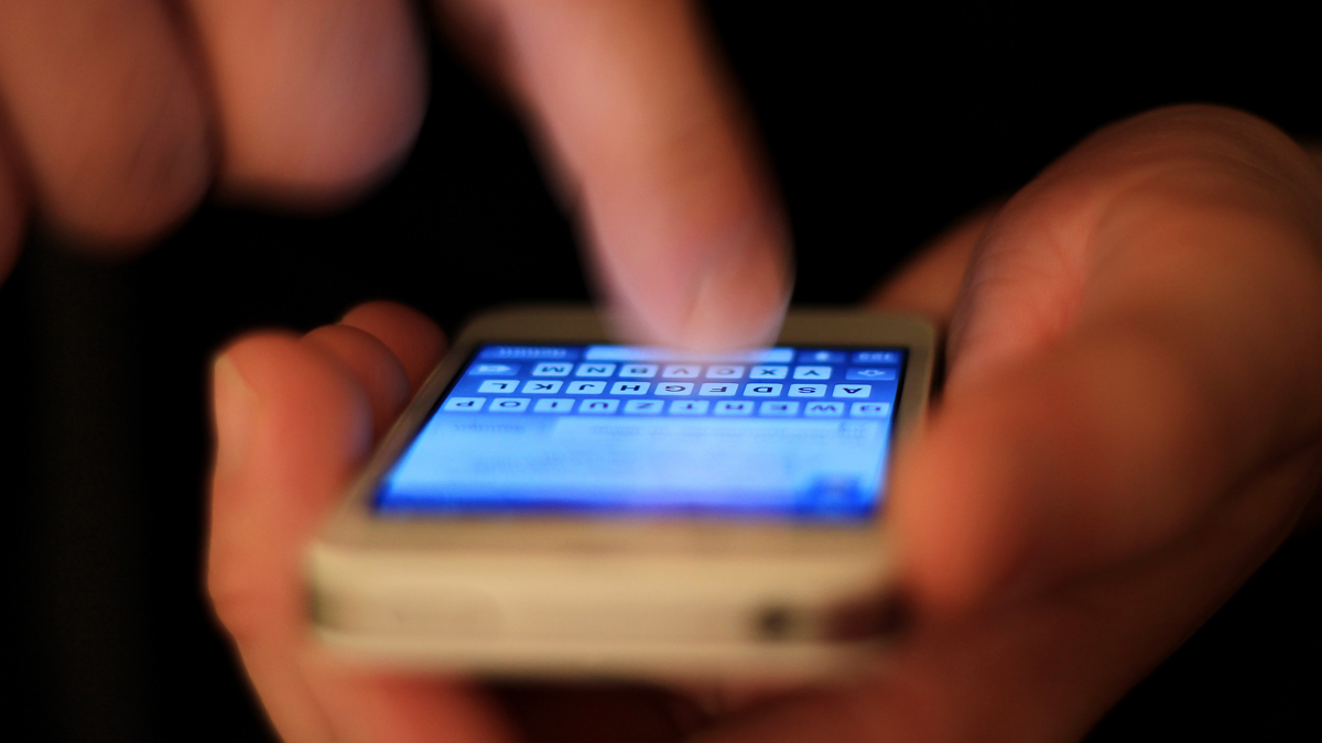 Photo of a person texting on a smart phone