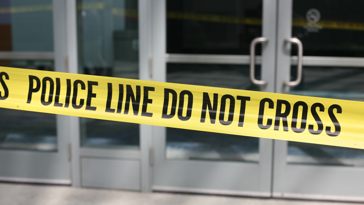 Photo of crime scene tape across plate-glass doors