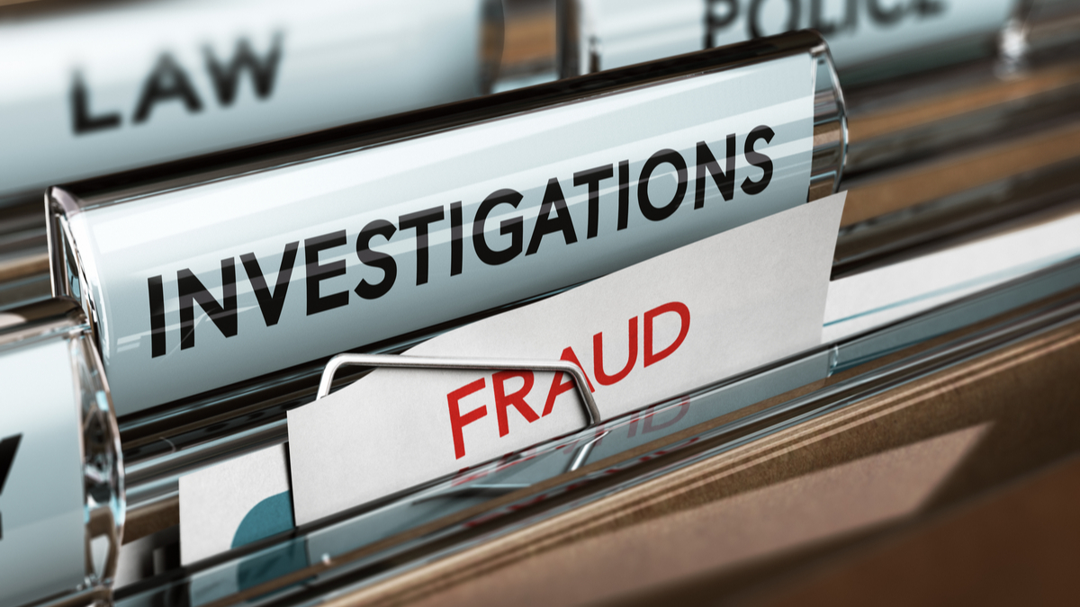 Photo of files marked fraud, investigations and law