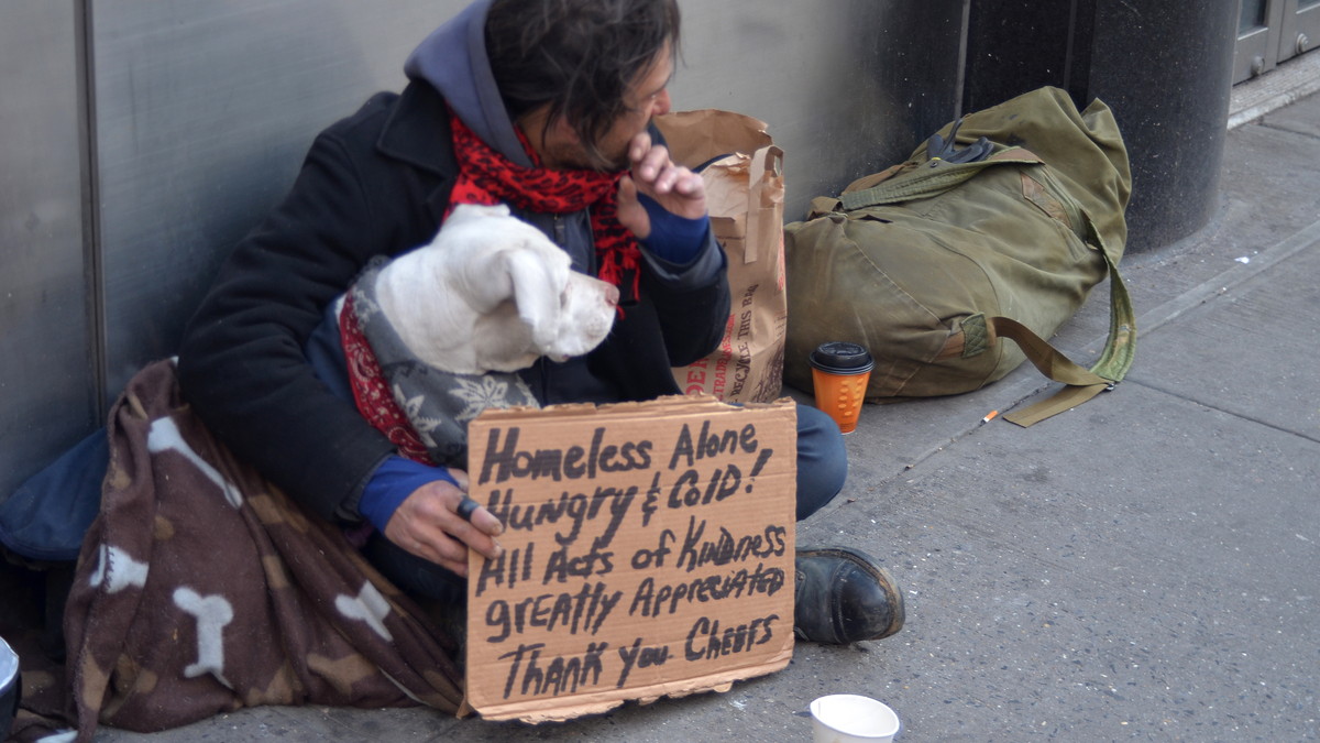Photo of a homeless man and his dog in New York City