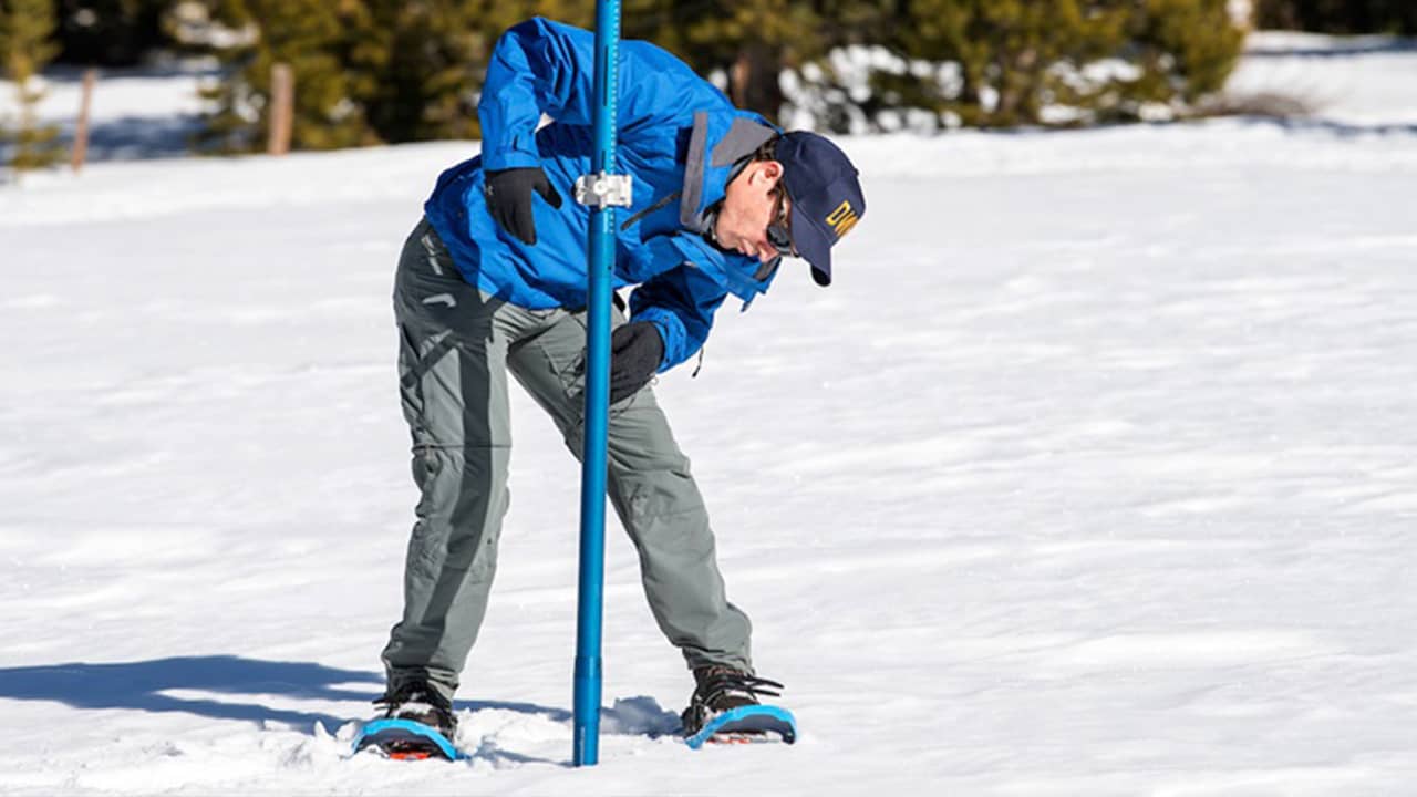Photo of worker taking snow survey at Phillips Station, California