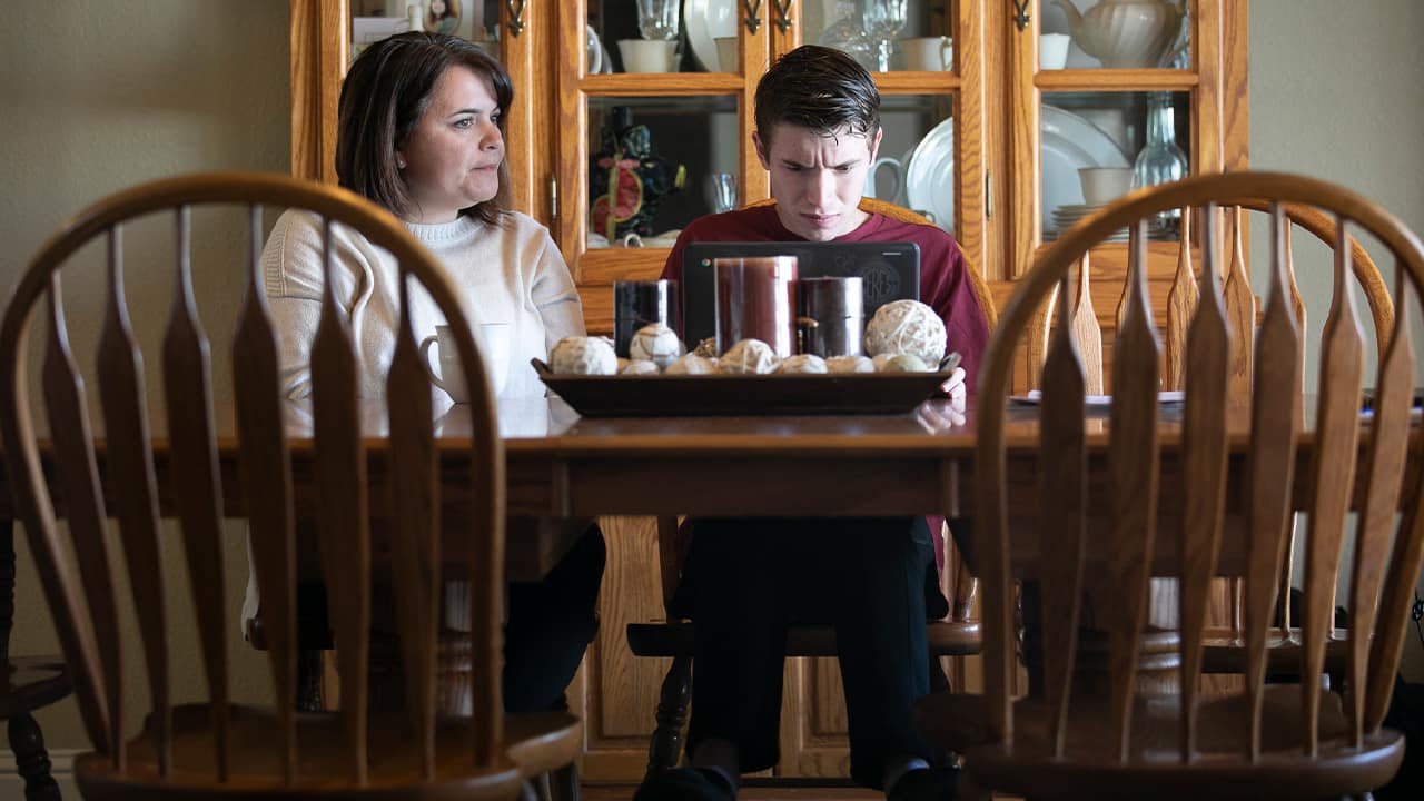 Photo of Linda Soars helping her son with homework 