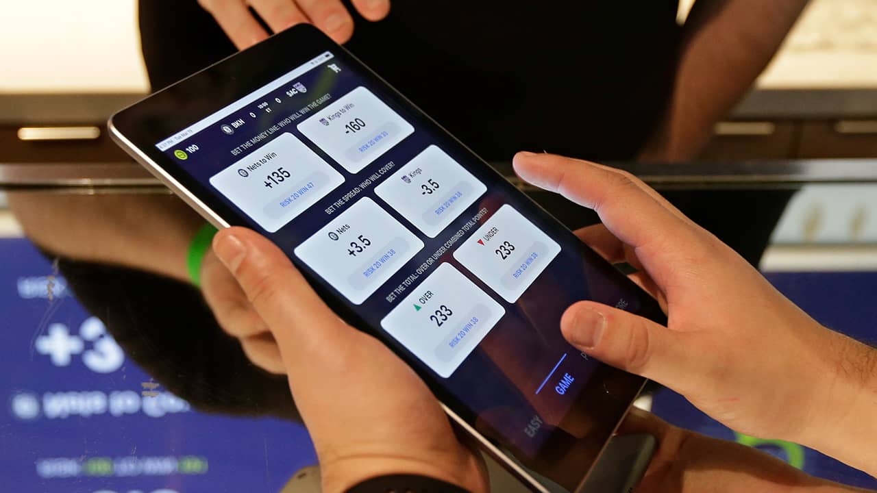 Photo of someone placing a bet at the Skyloft Predictive Gaming Lounge