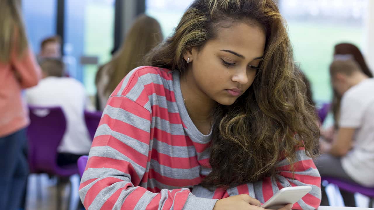 Photo of a female student looking at her smartphone