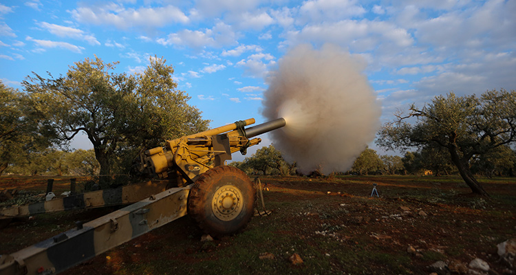 Photo of Turkish back Syrian fighters firing a howitzer in Neirab 
