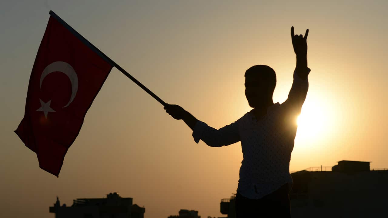 Photo of someone holding a Turkish flag 