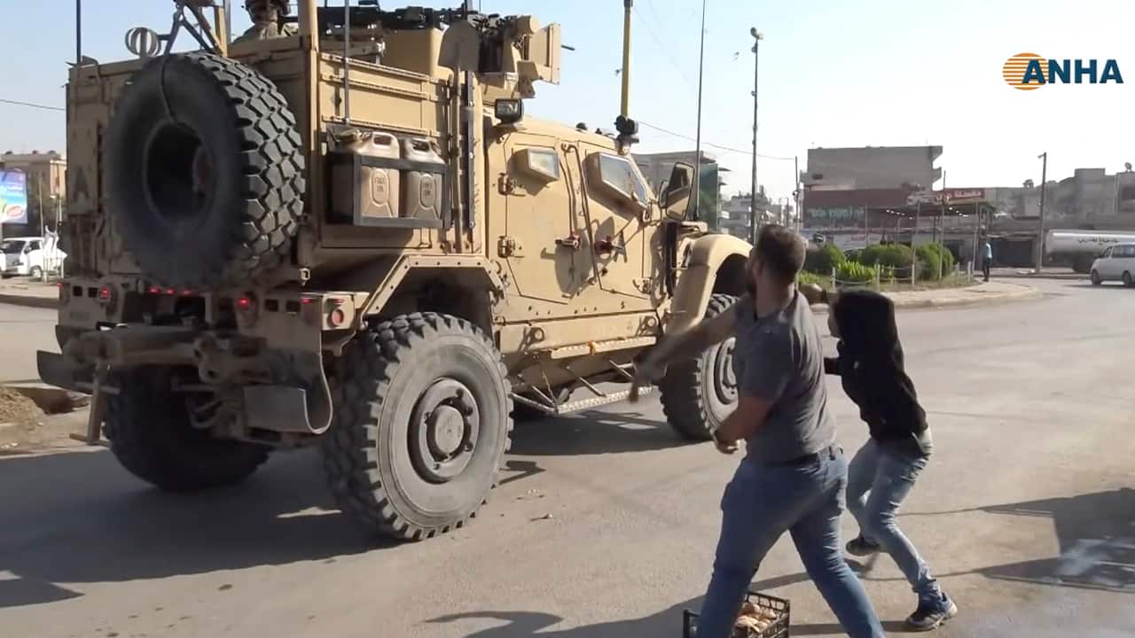 Photo of residents throwing potatoes at military vehicles