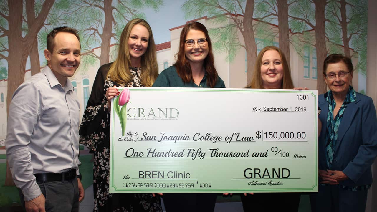 Photo of check presentation of $150,000 from GRAND to the SJCL for the BREN Clinic
