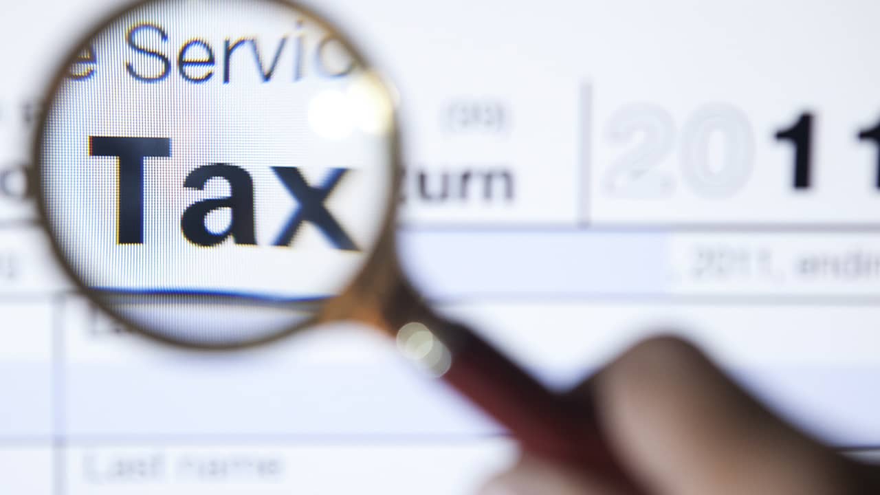 Photo of tax form and a magnifying glass