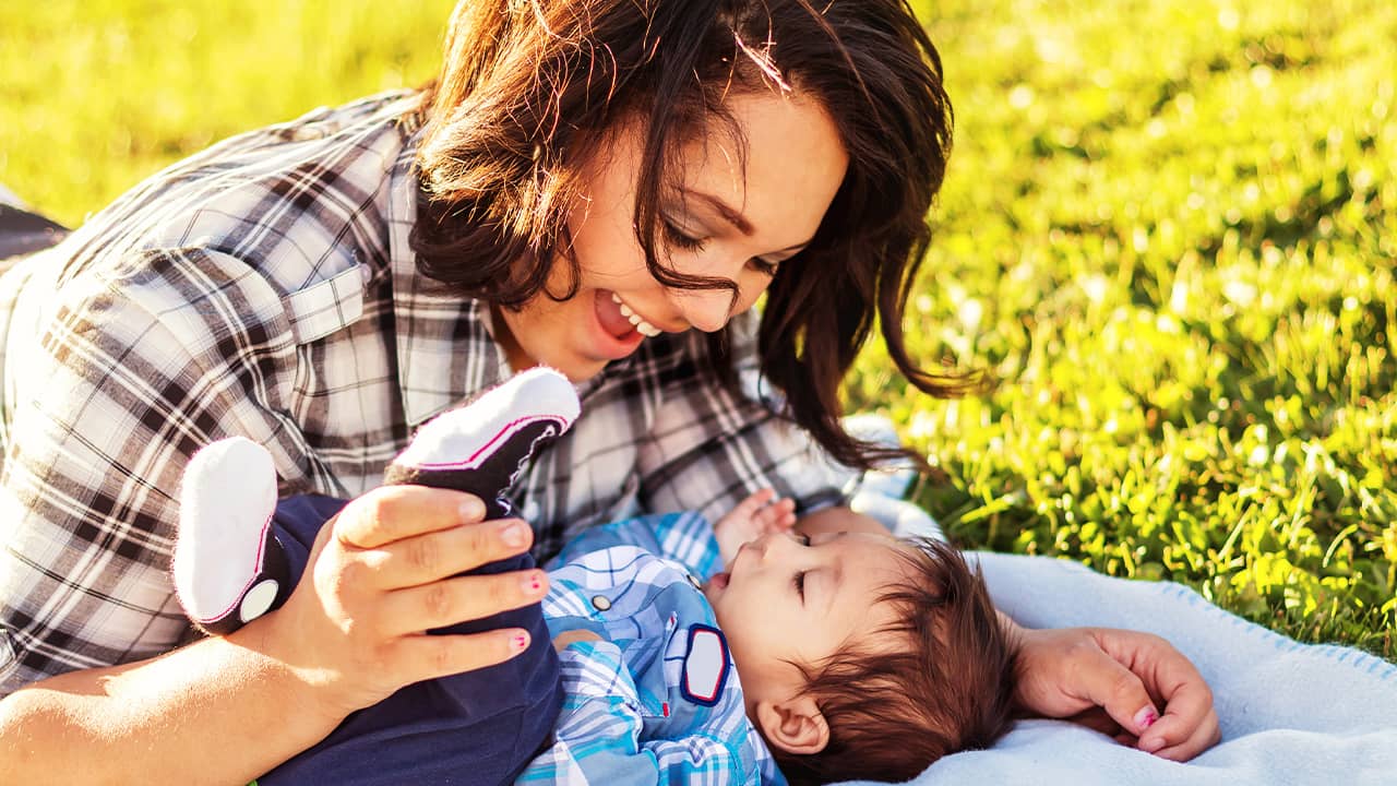 Photo of a teenaged mother spending time with her baby