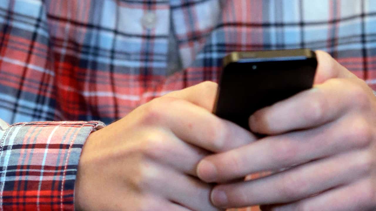 Photo of a person texting on their cellphone
