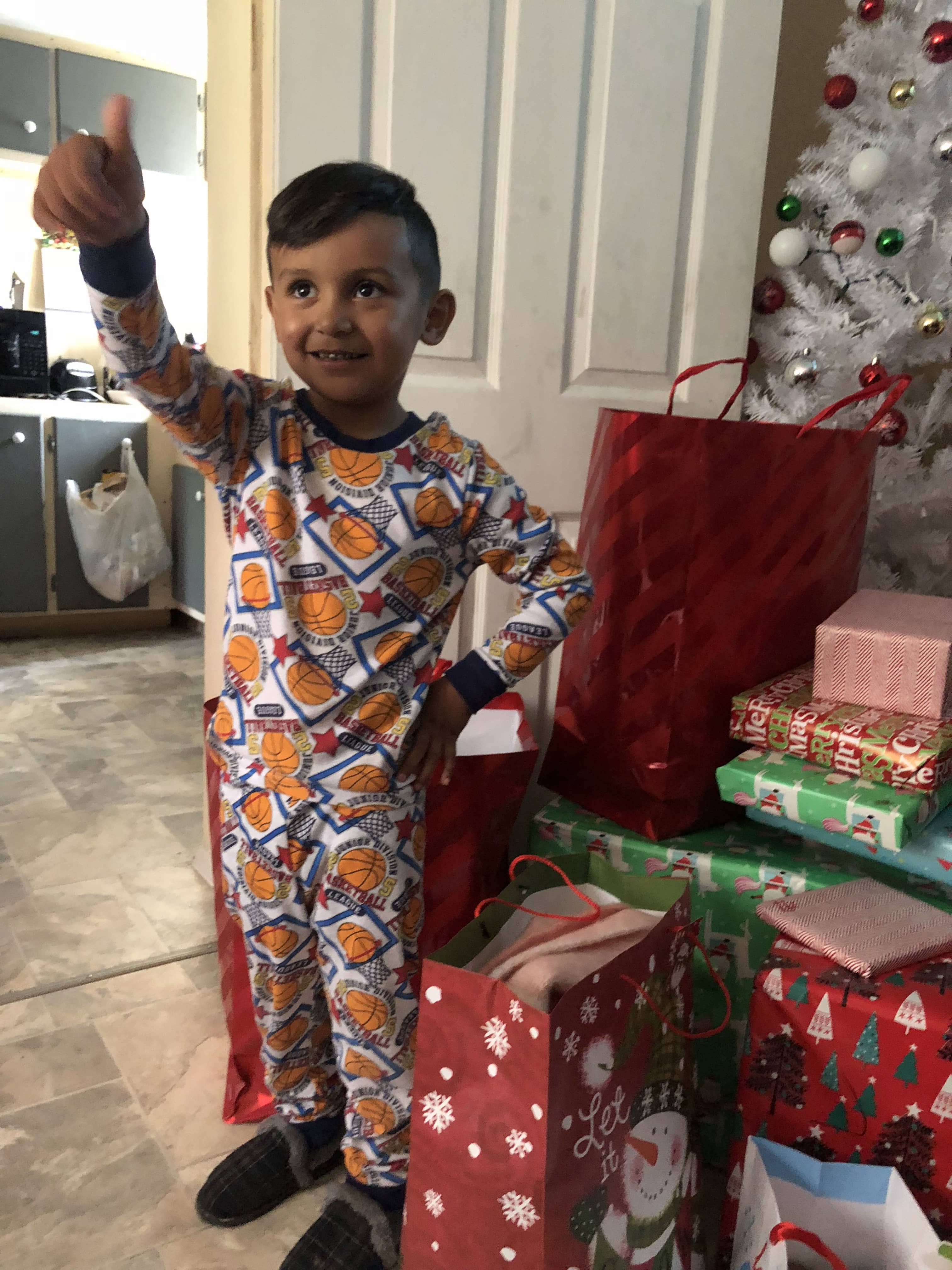 Photo of a boy in Mendota, CA, giving a thumbs up for his Christmas gifts