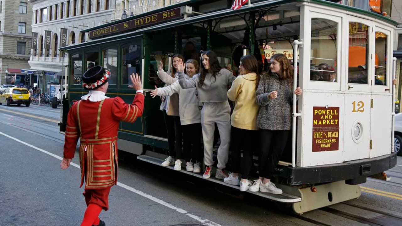 Photo of Tom Sweeney greeting trolly riders in San Francisco