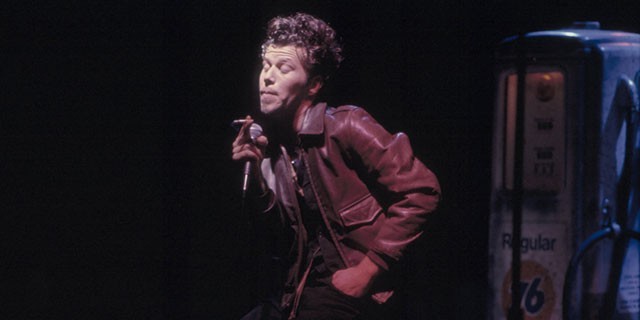 Photo of Tom Waits singing
