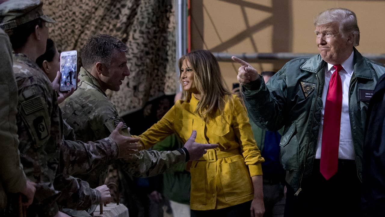 Photo of President Donald Trump and Melania Trump getting US troops in Iraq