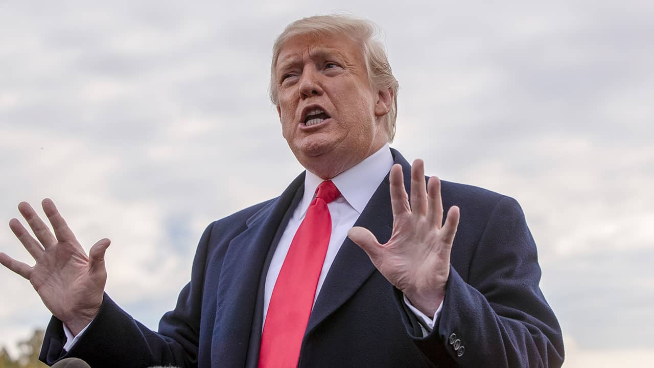 Photo of President Donald Trump talking to reporters